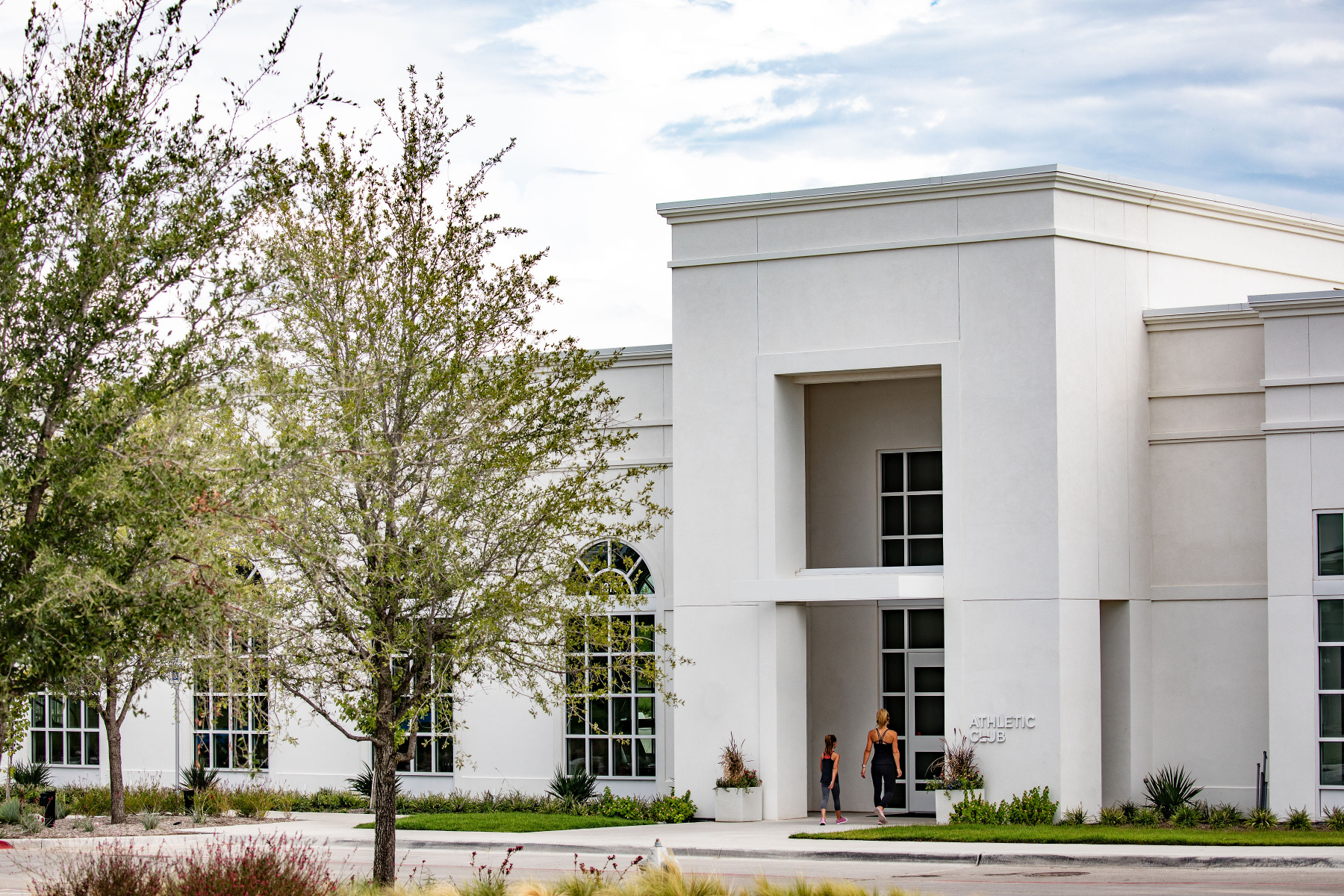Mom and daughter walk into the Walsh Athletic Club