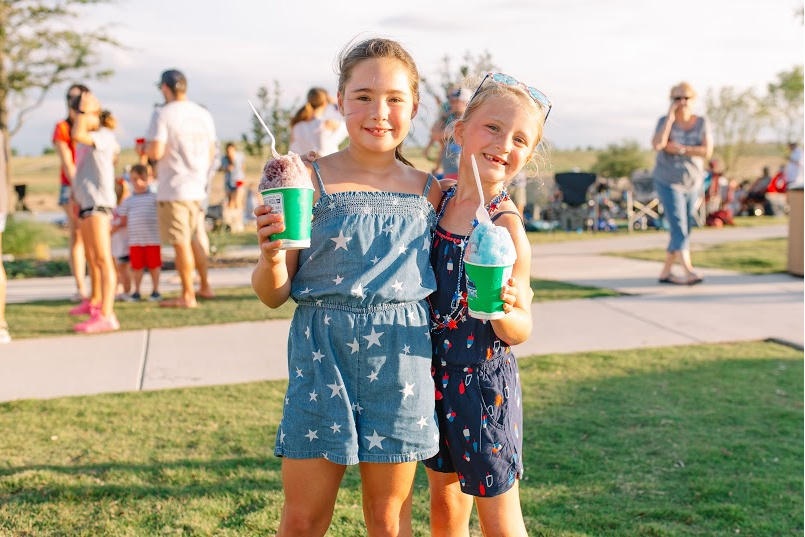 Children enjoying Kona Ice snow cones.