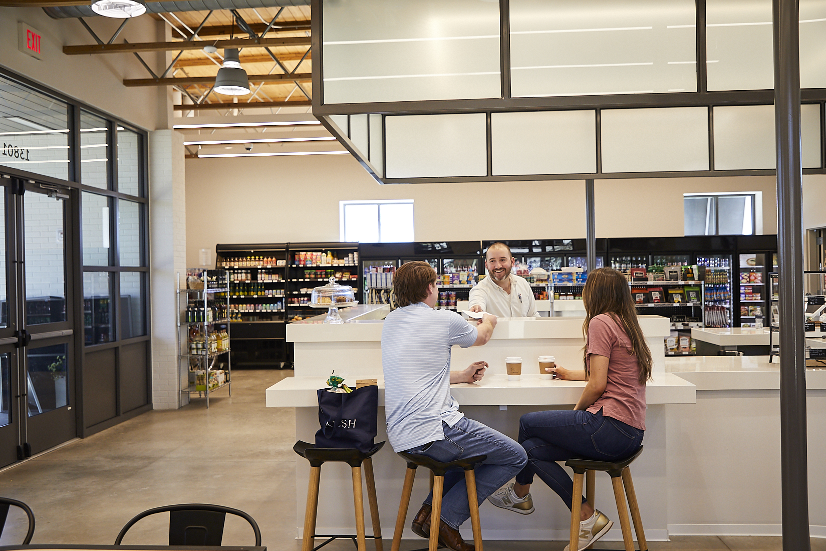A couple talks at the counter of the Village Market