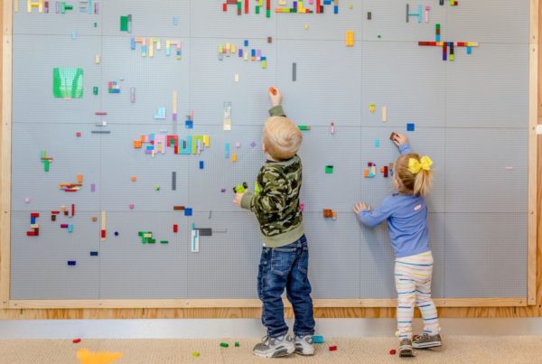 Kids playing with Lego wall