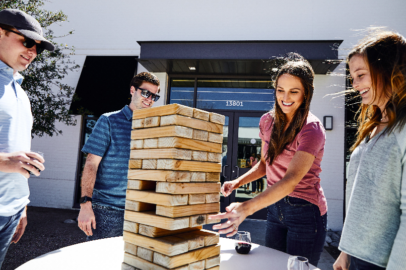 Friends playing Jenga outside the Village Market