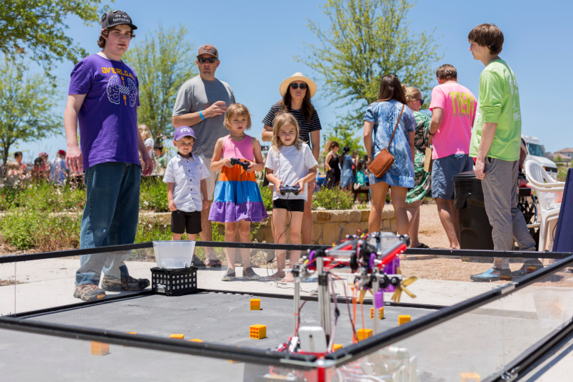 Children operating robotics during Makerfest at the Makerspace