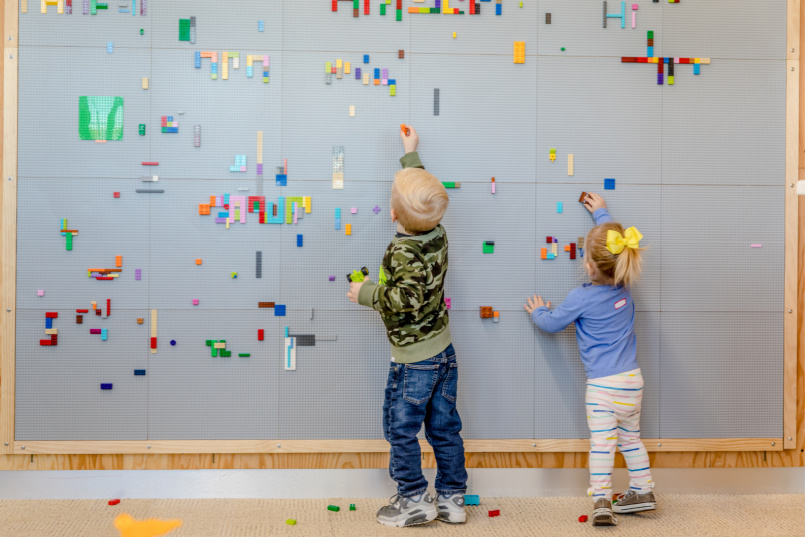 Children using the Lego wall in the Makerspace
