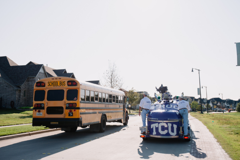 TCU mascot waves to Aledo ISD school bus