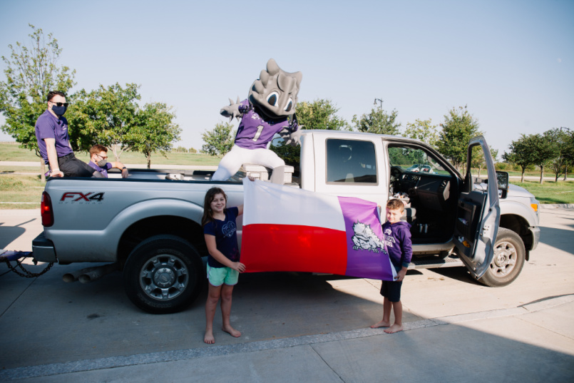 TCU fans hold a flag during drive-by