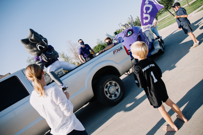 Child throws a football with SuperFrog