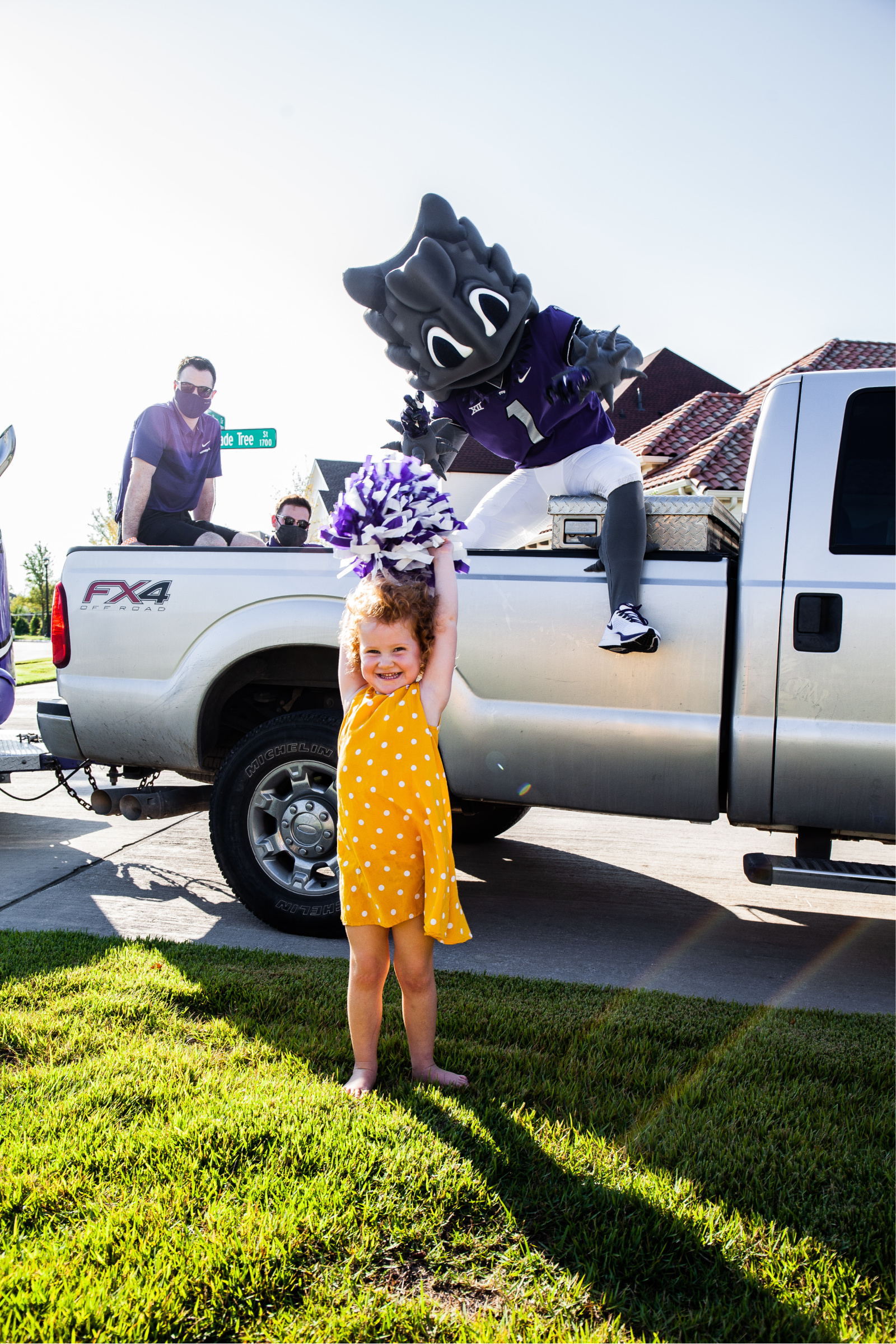 A future frog cheers on SuperFrog during his neighborhood drive-by
