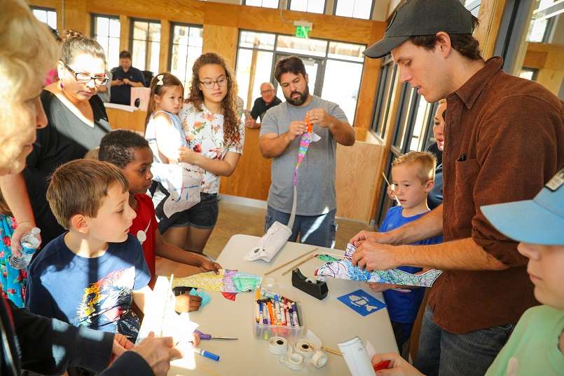 Families take part in a kite making class.