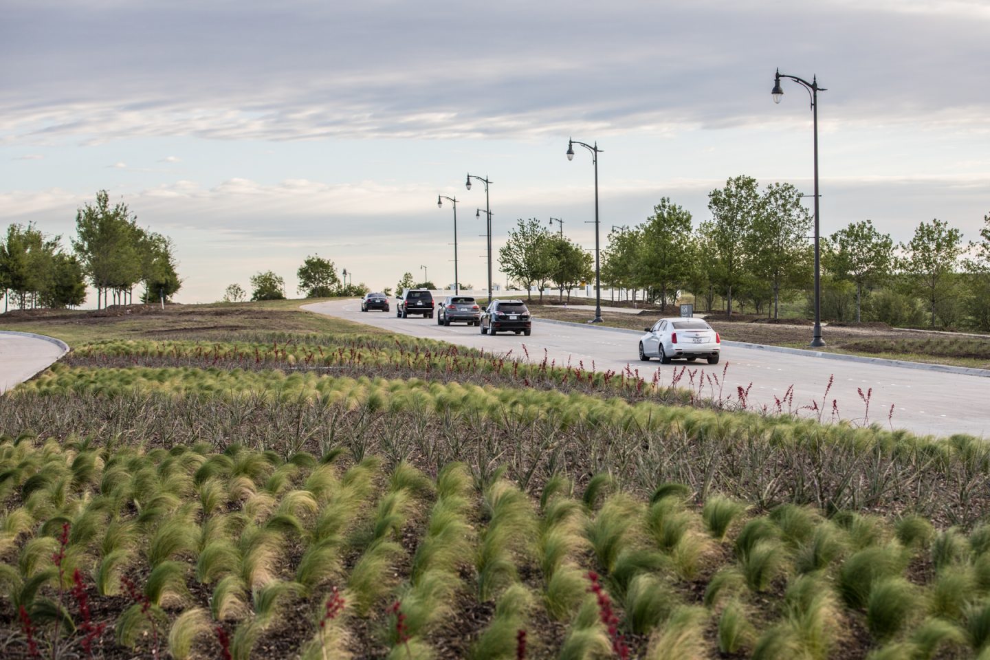 The first few cars enter the community headed towards the model park on opening day.